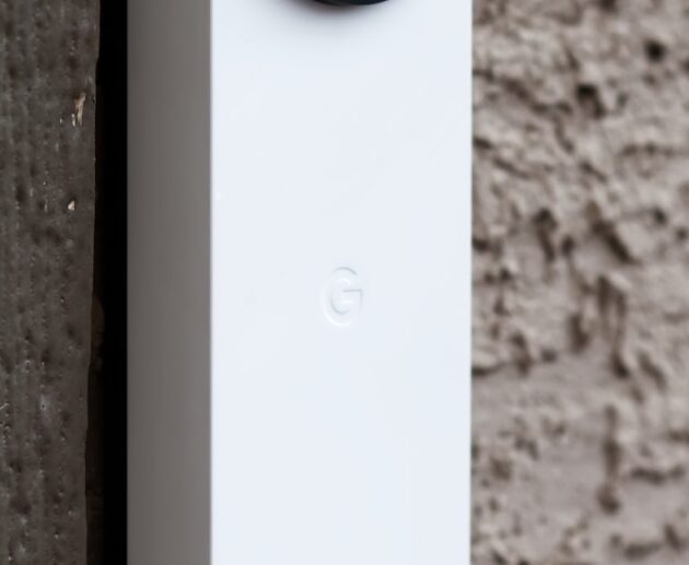 Modern smart doorbell camera mounted beside a front door frame