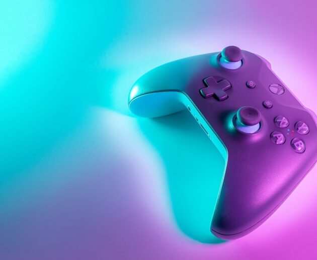 Wireless gaming controller with an Xbox-style layout lit against a colored background