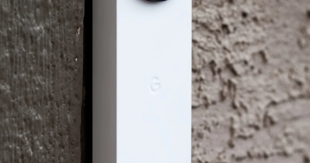 Modern smart doorbell camera mounted beside a front door frame
