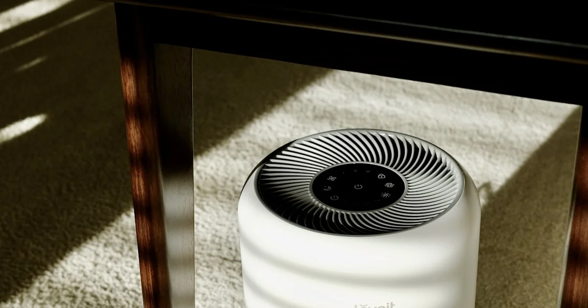 A compact HEPA air purifier running on the floor of a sunlit living room, one of the top air purifiers for allergies under 150