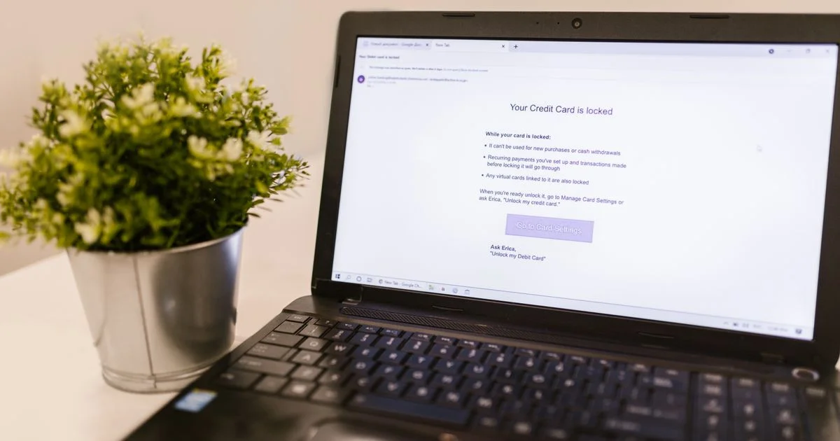 A Windows laptop on a table showing a bank card-lock alert, the moment antivirus software for Windows PC is bought for