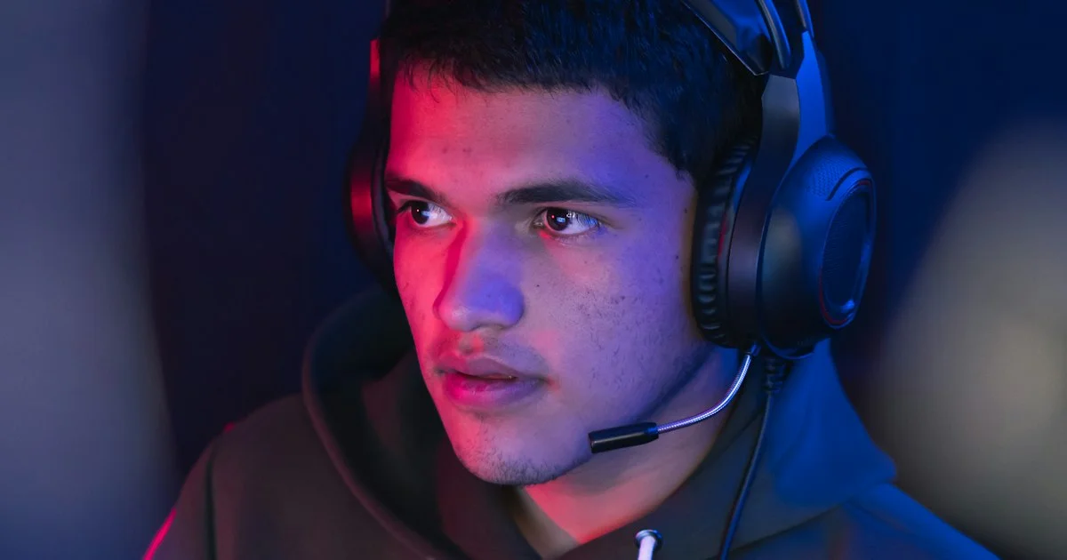 Player wearing a gaming headset with good mic quality, boom microphone positioned near his mouth