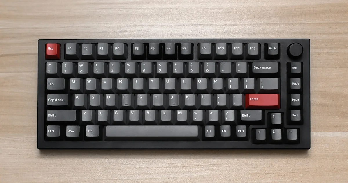 Compact mechanical keyboard on a wooden desk, the kind found among the cheapest mechanical keyboards under 50