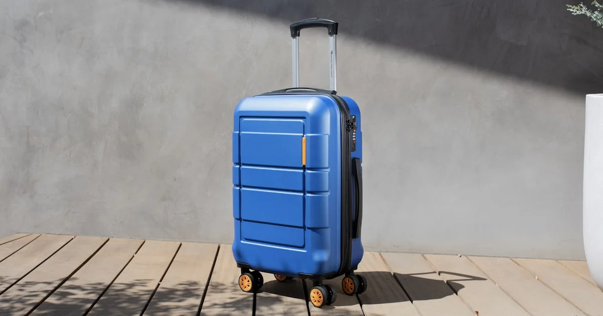 Blue hard-shell carry-on spinner suitcase, the size used for the cheapest smart luggage for international travel