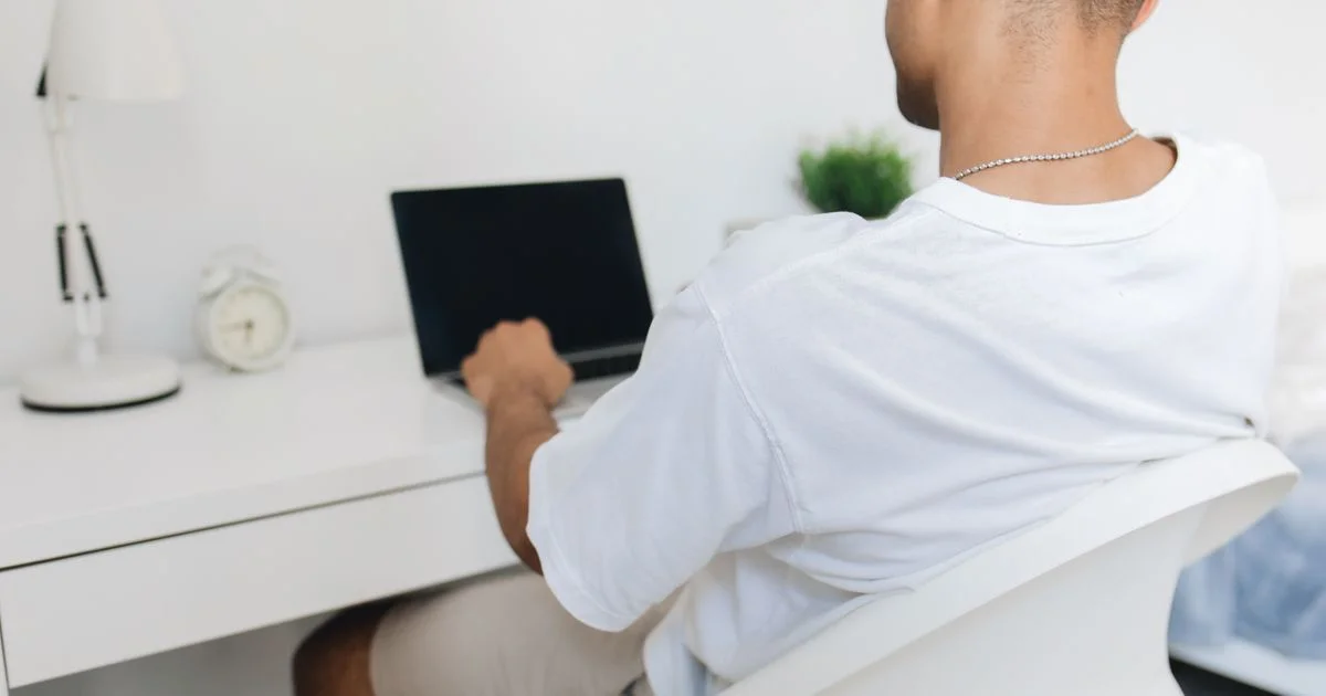 A man studying at a home desk in the evening, the routine behind any online learning platform for career changers