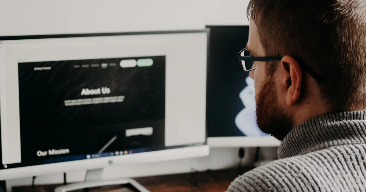 Owner reviewing an About Us page made with a website builder for small businesses