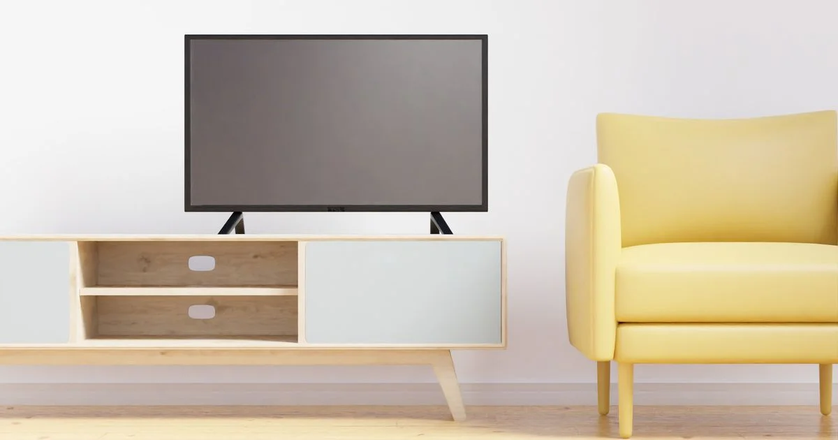 A flat-screen television on a low stand with an empty open shelf below it, the space a refurbished game console for budget gamers has to fit